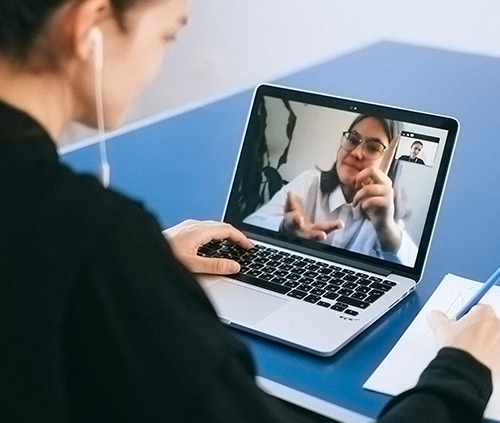 High school student taking an online class with headphones on image